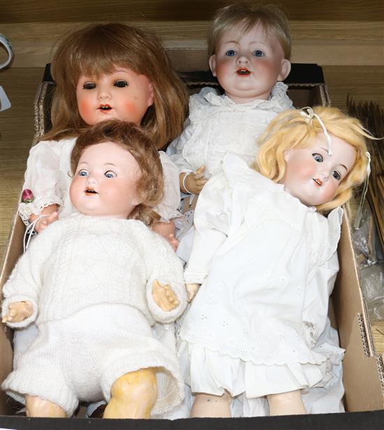 A group of four bisque-headed dolls with jointed composition bodies,